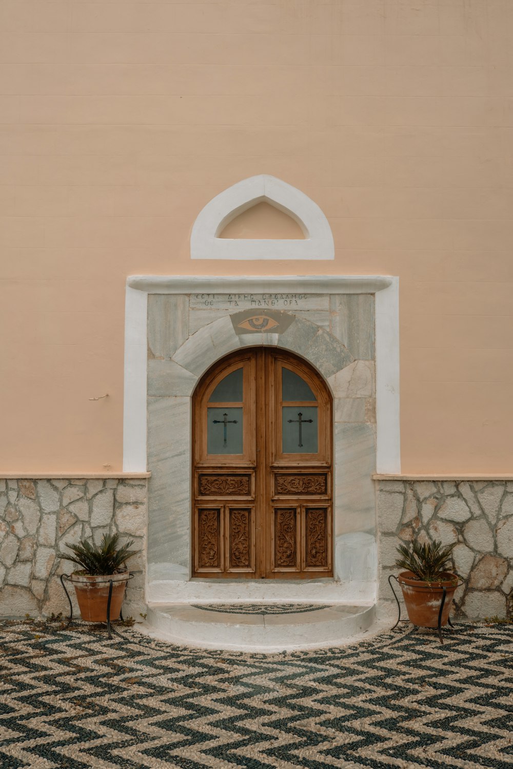 a large wooden door sitting next to a wall