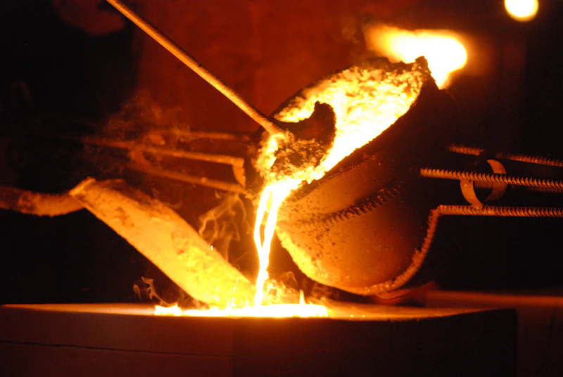 Metal being smelted over a fire pit