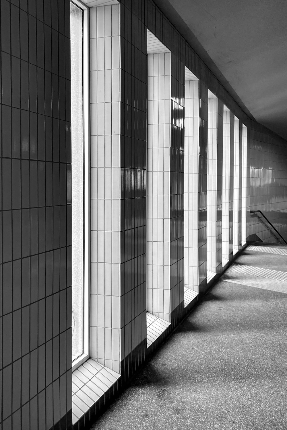 a black and white photo of a row of windows