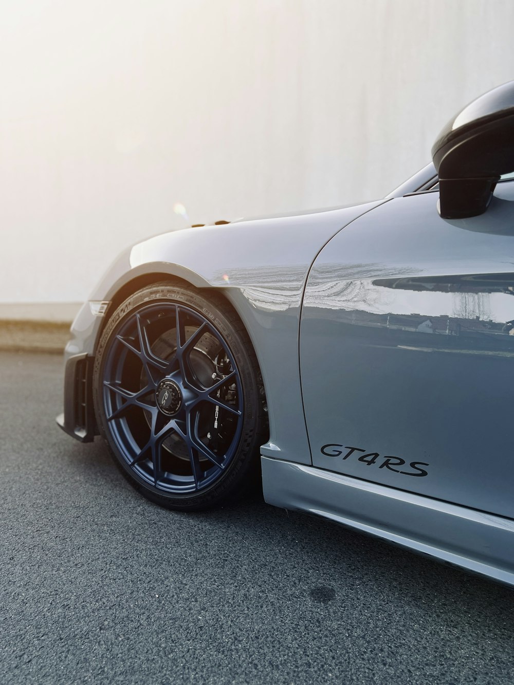 a grey sports car parked on the street