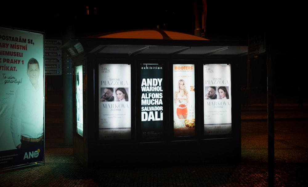 a bus stop sitting on the side of a road