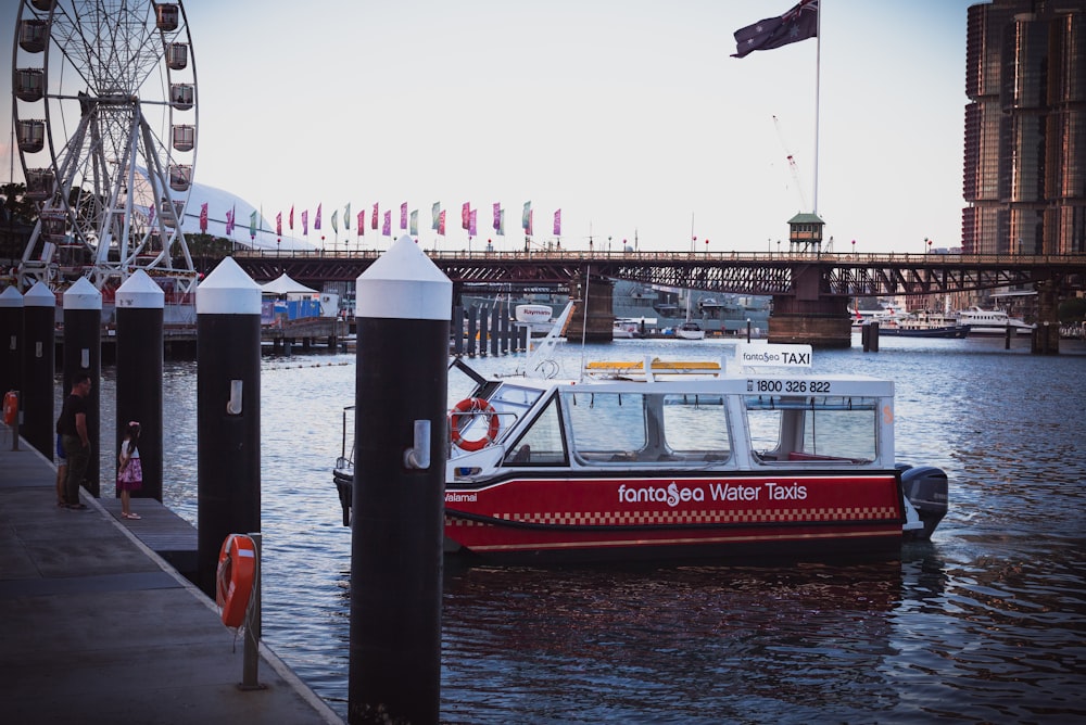 a red and white boat in a body of water