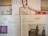 Several newspapers and magazines are arranged on a wooden surface. One magazine features a portrait of a woman with wet hair in a white top. Below are pages from a German newspaper with articles and images, including one of a man in a suit. The Economist magazine is partially visible on the right.