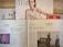 Several newspapers and magazines are arranged on a wooden surface. One magazine features a portrait of a woman with wet hair in a white top. Below are pages from a German newspaper with articles and images, including one of a man in a suit. The Economist magazine is partially visible on the right.