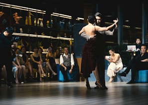 Night scene of tango dancers performing in an intimate Buenos Aires venue.