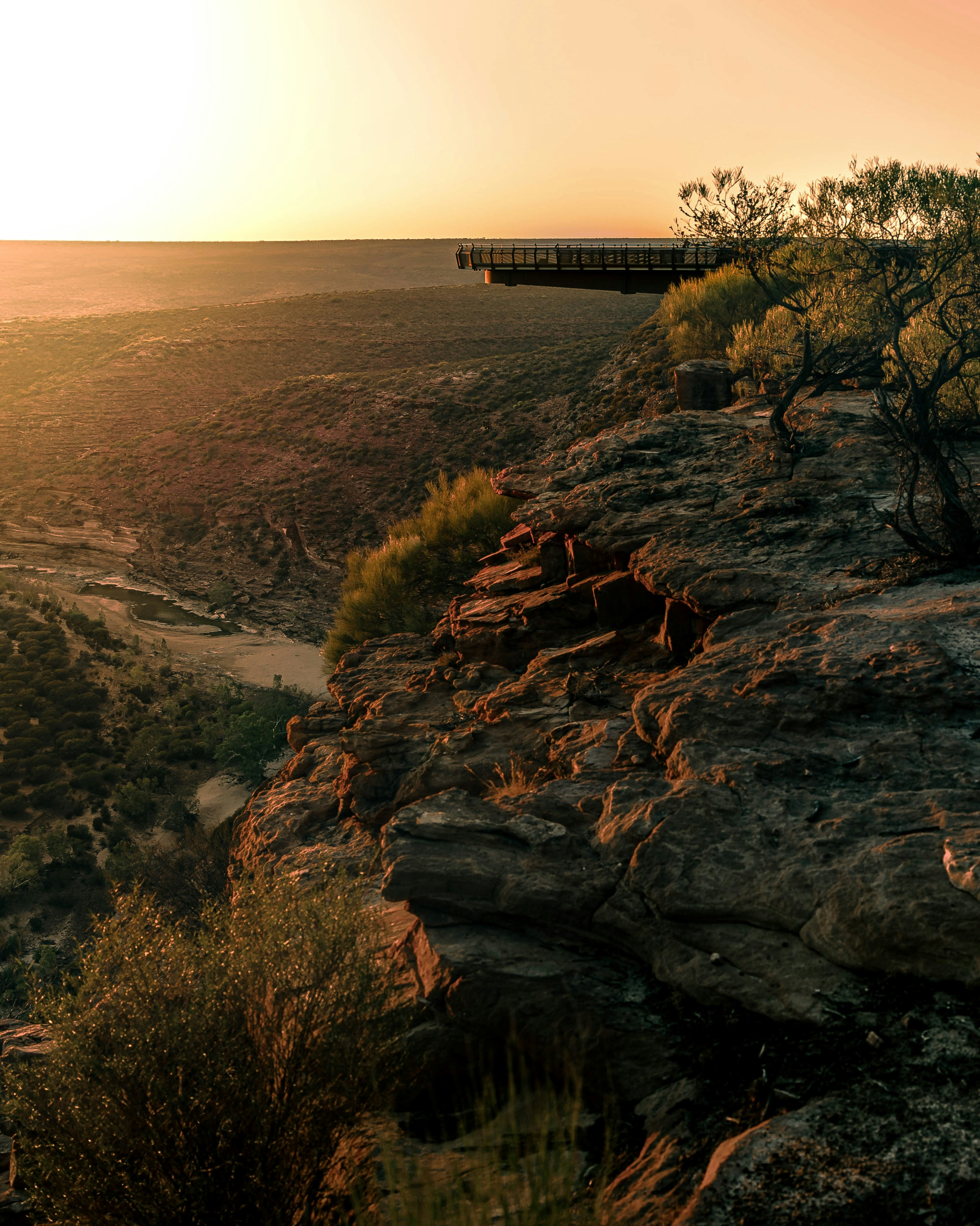 a train traveling over a bridge on top of a mountain