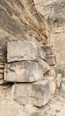 Large gres stone slabs leaning against a warehouse wall.