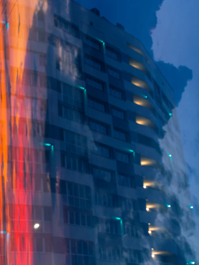 A sleek, modern apartment building in Bahrain bathed in warm evening light, reflecting the city’s vibrant urban lifestyle.