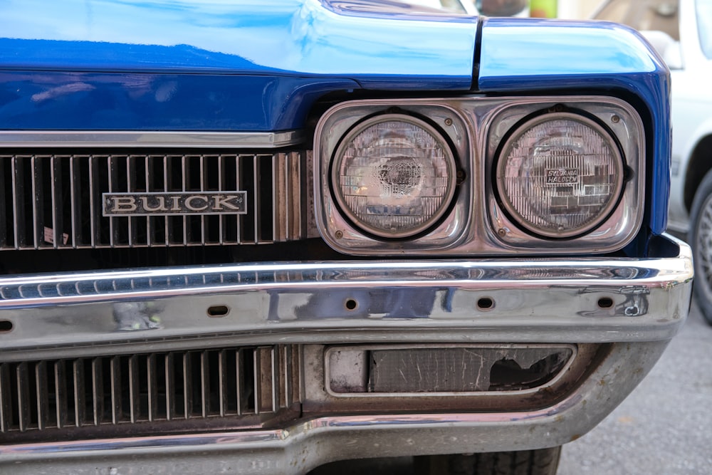 a close up of the front of a blue car