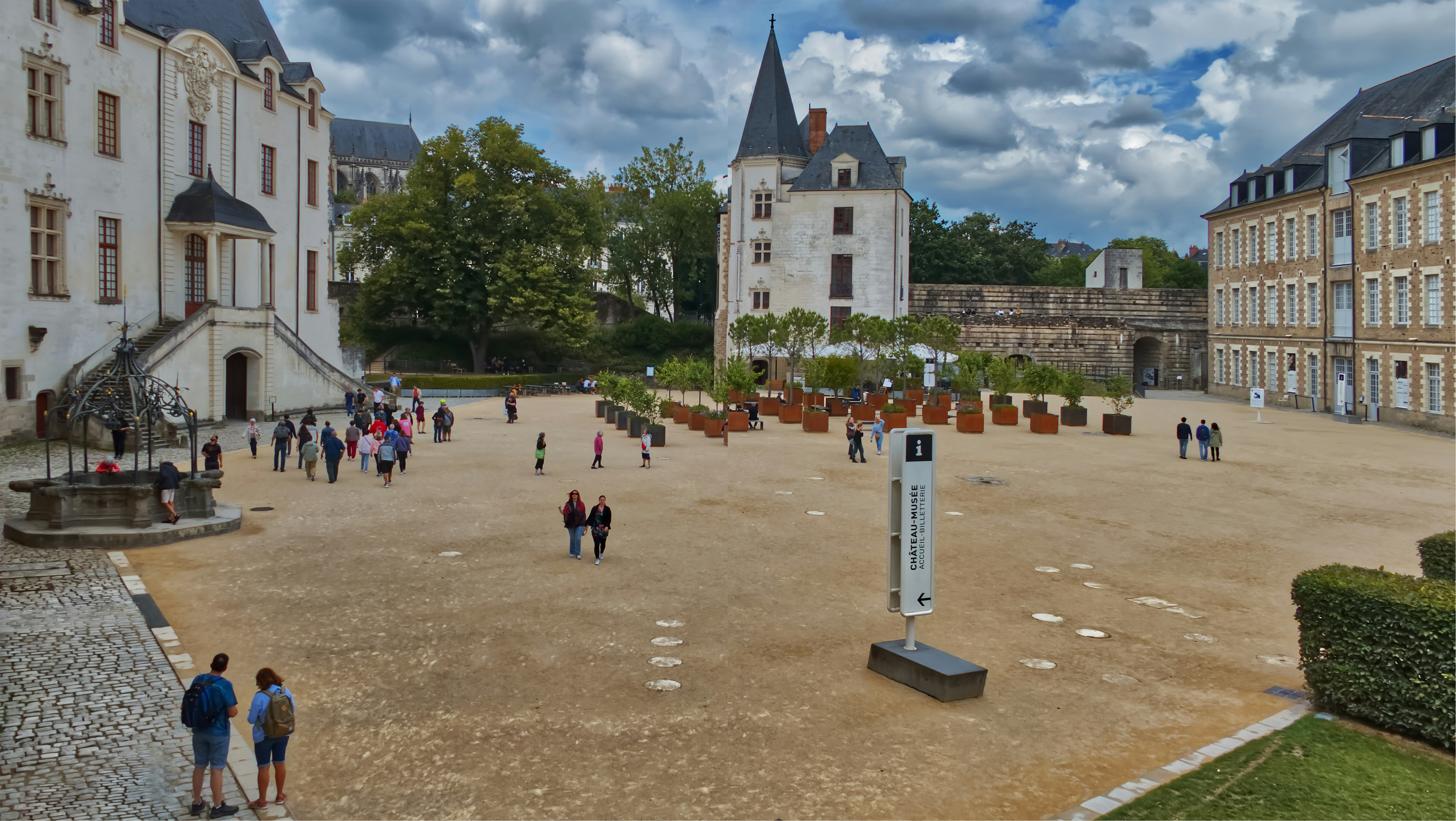 a group of people walking around a courtyard