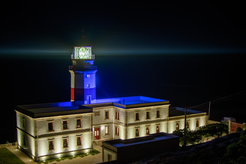 a building with a clock tower lit up at night