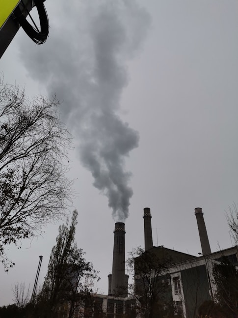 a factory with smoke coming out of it's stacks