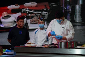 a group of chefs preparing food in a kitchen