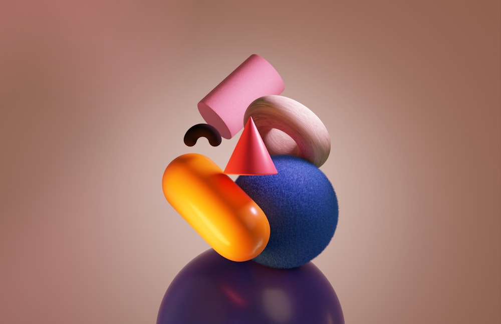 a colorful object sitting on top of a purple ball