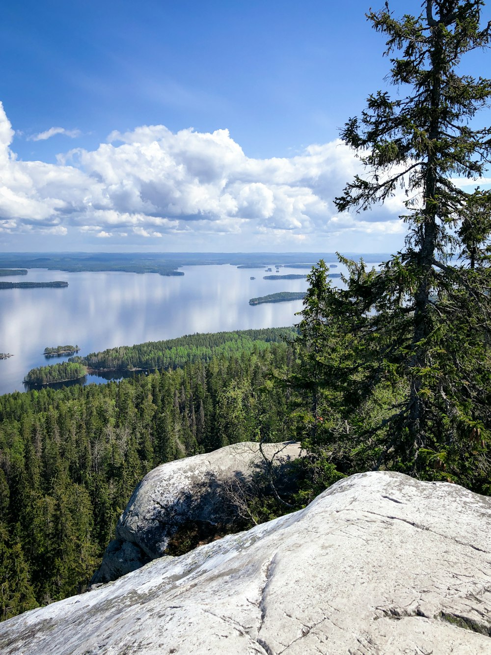 a person standing on top of a mountain overlooking a lake