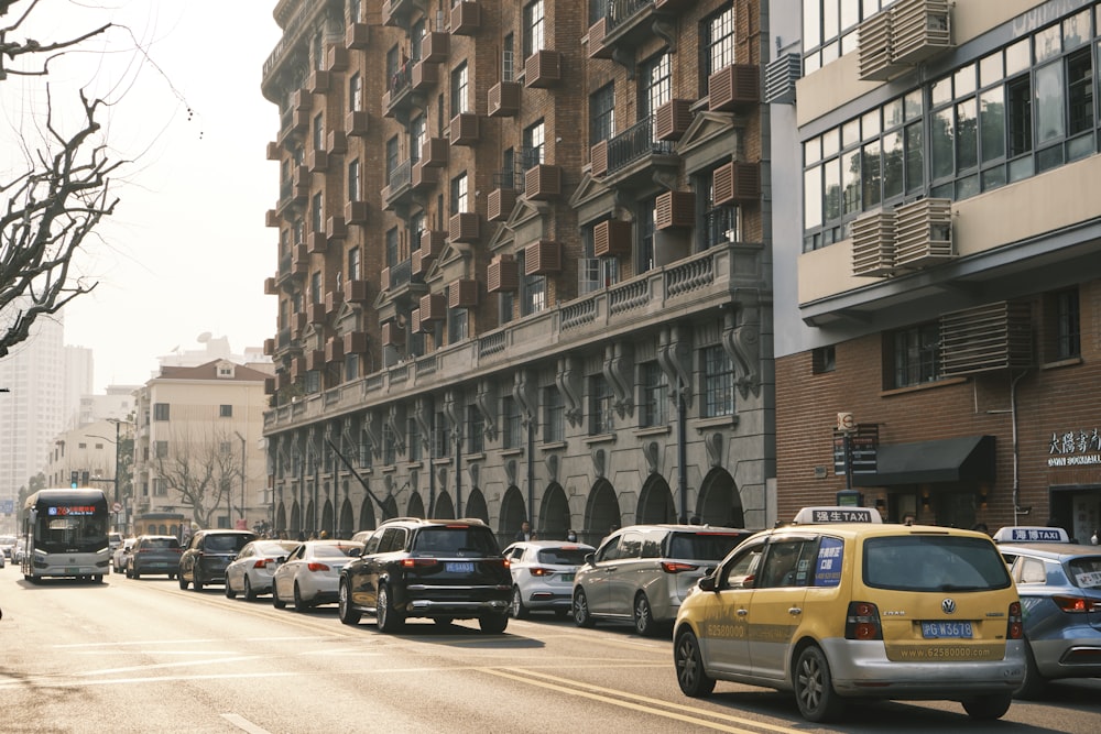 a street filled with lots of traffic next to tall buildings