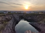A sunset shot over a restored quarry landscape blending naturally with surrounding terrain.