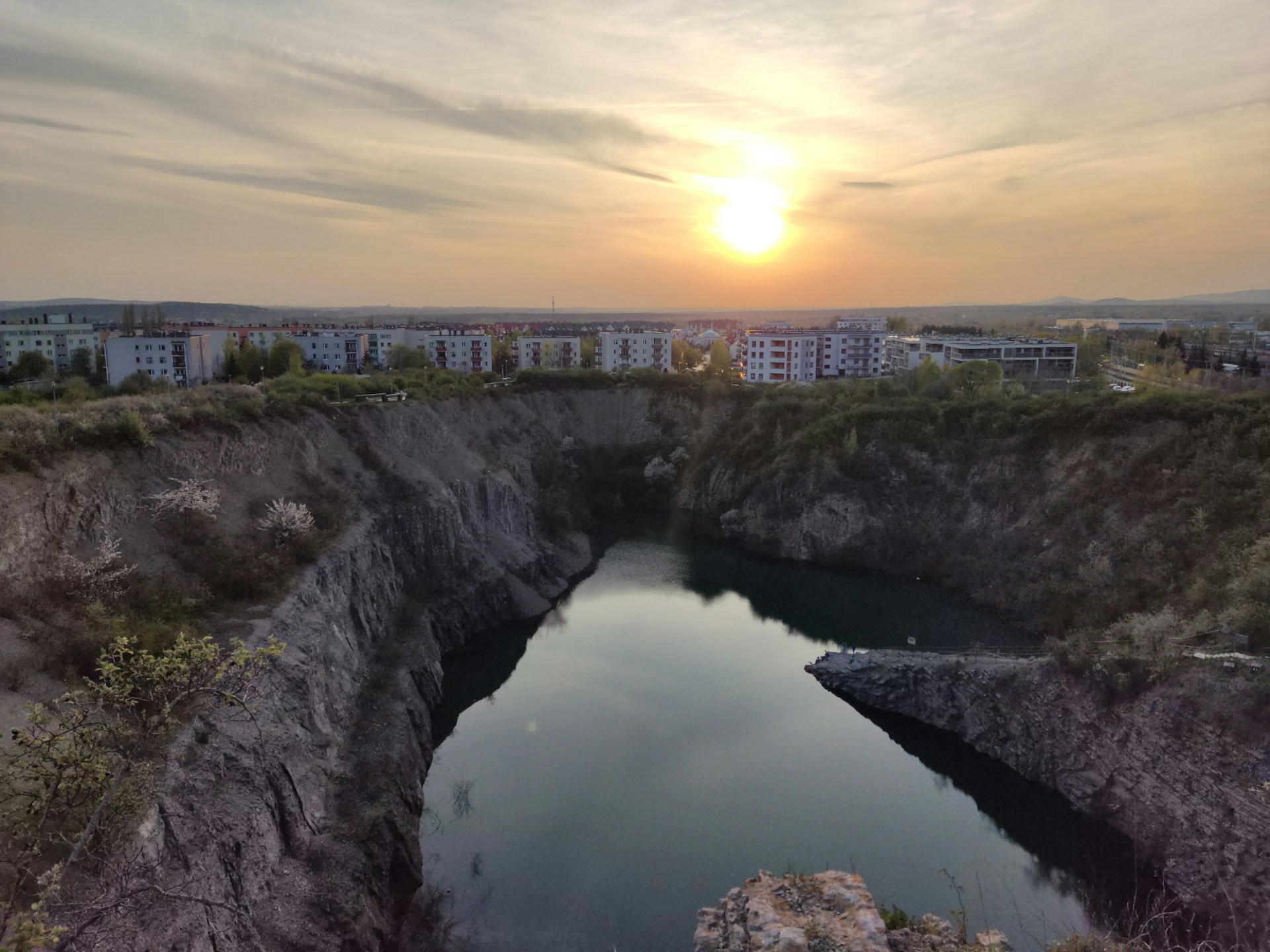 A serene residential plot at sunset in Madurai, showcasing well-laid roads and lush greenery developed by Land Qube Infra.
