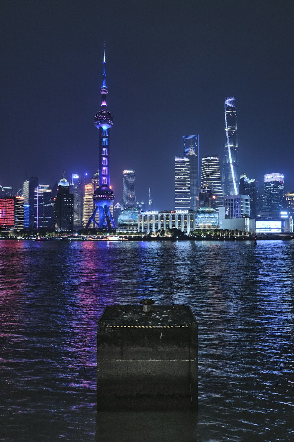 a large body of water with a city in the background