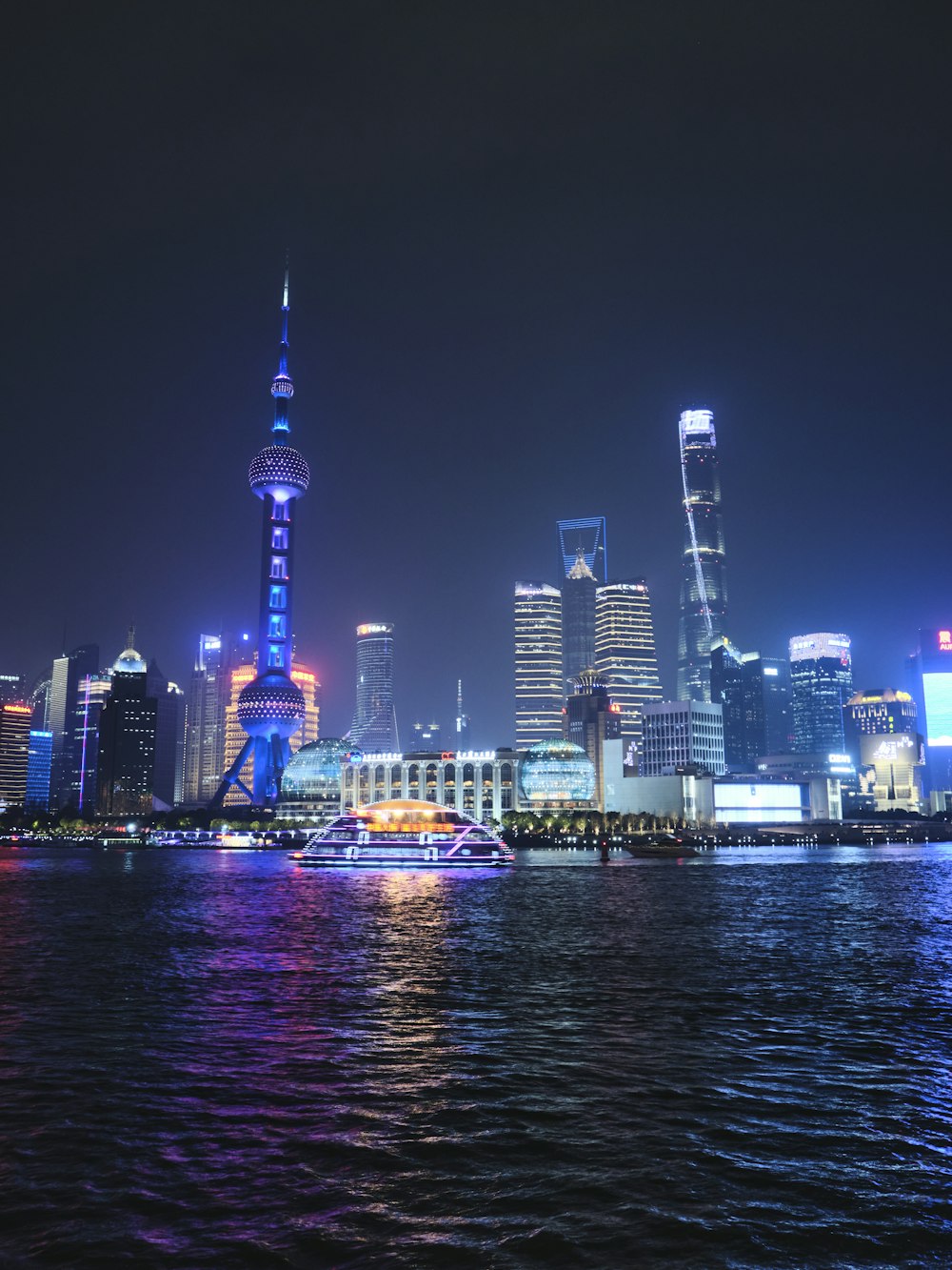 a large body of water with a city in the background