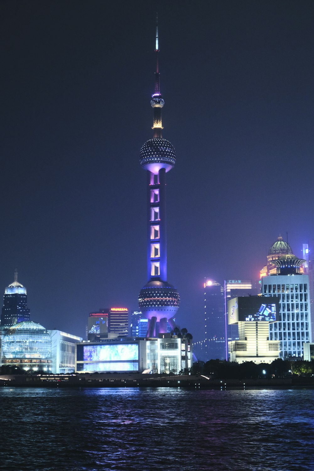 the oriental city skyline is lit up at night