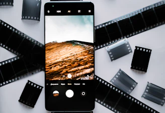 A cinematic reel playing on a sleek smartphone held by a smiling viewer.