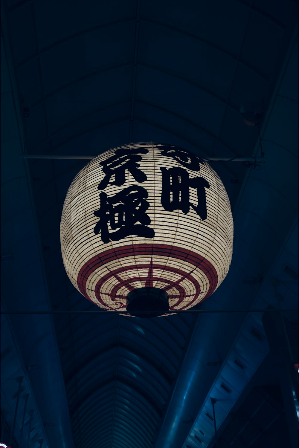 a large lantern hanging from the ceiling of a building