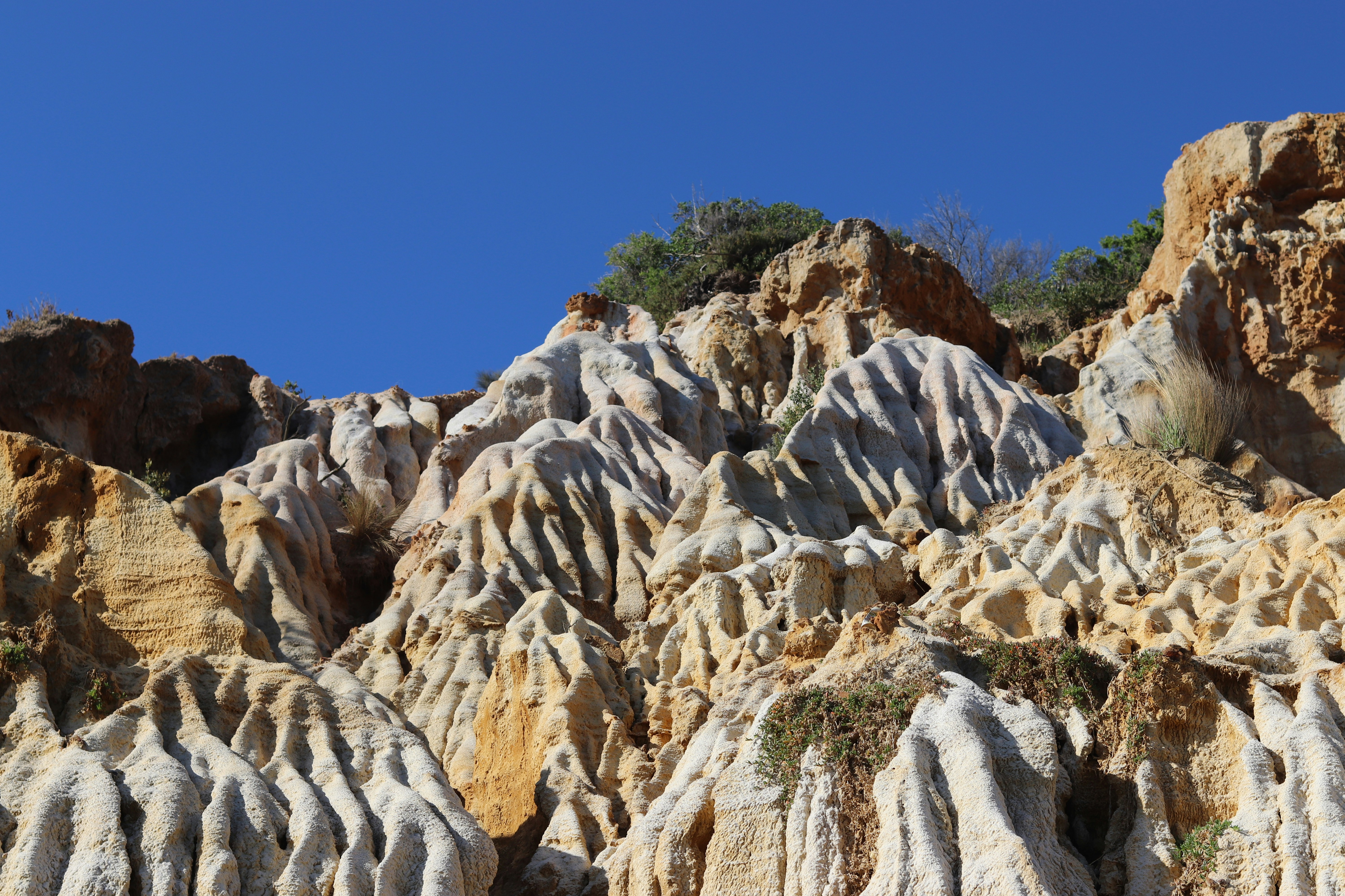 a group of rocks with a blue sky in the background