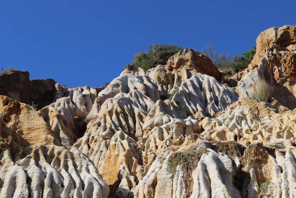 a group of rocks with a blue sky in the background