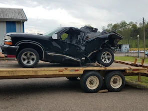 Professional tow truck carefully loading a damaged car after a collision.
