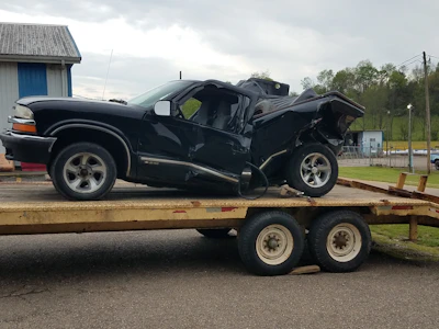 A close-up of a damaged car being loaded onto a tow truck in Miami Beach.