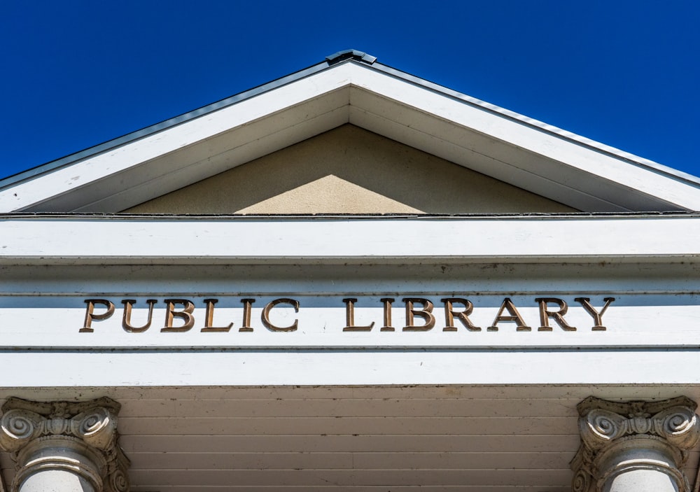a building with a sign that reads public library