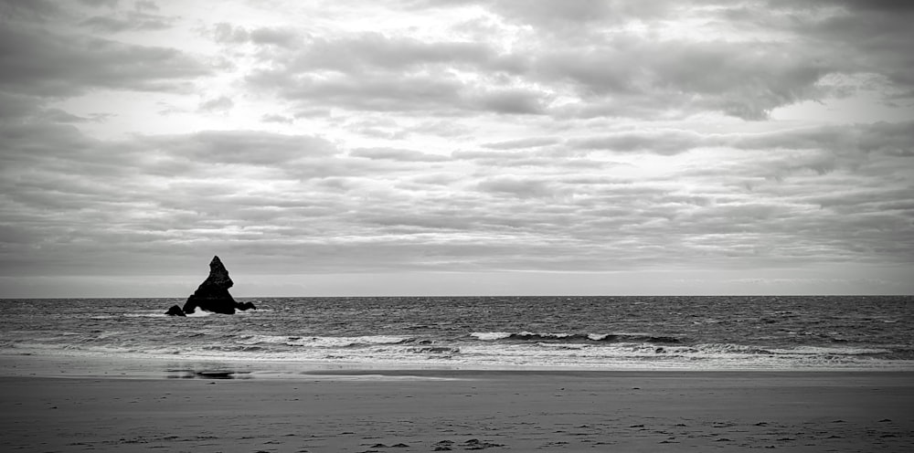 a black and white photo of a person on a surfboard