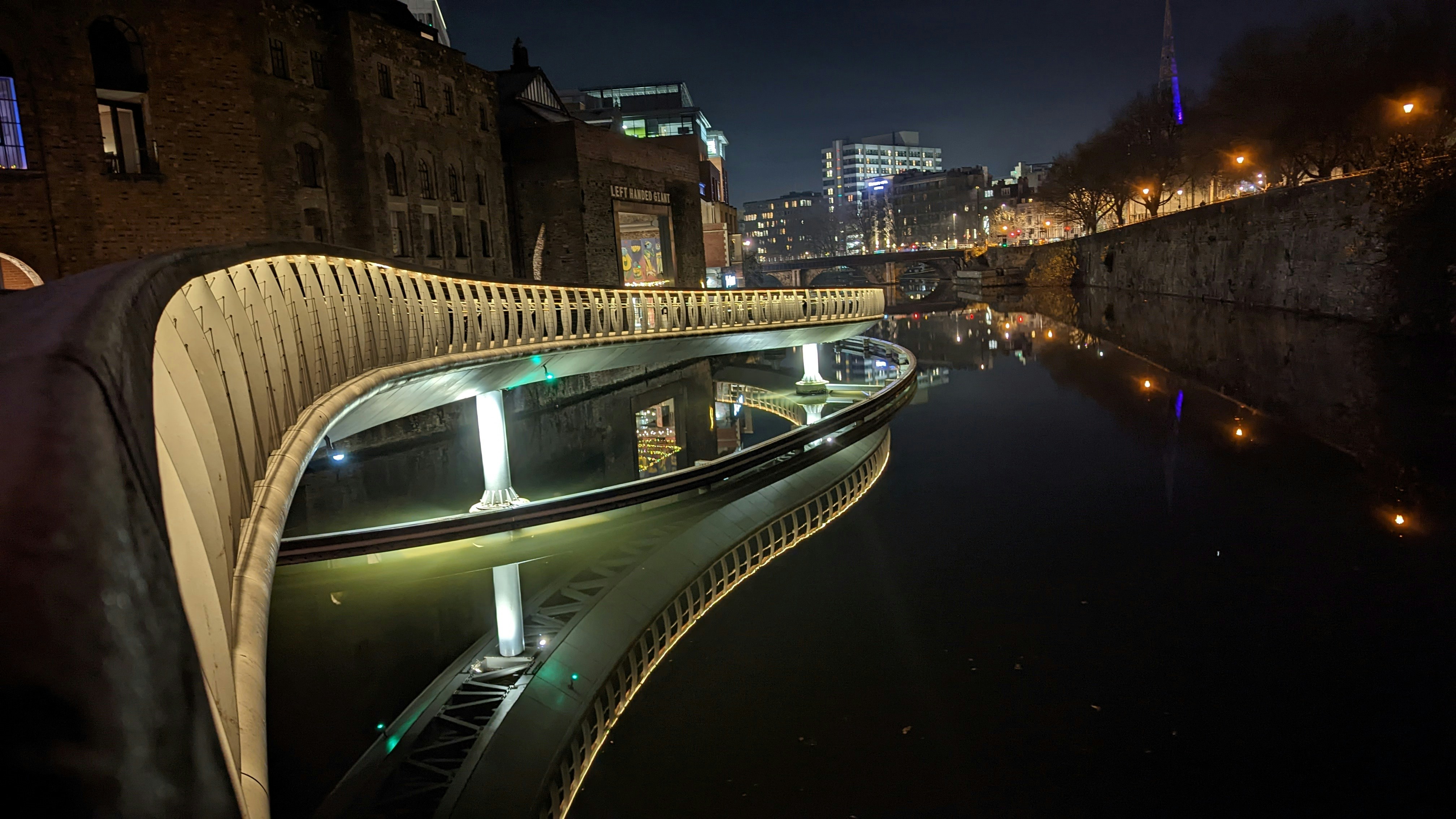 a view of a bridge over a river at night