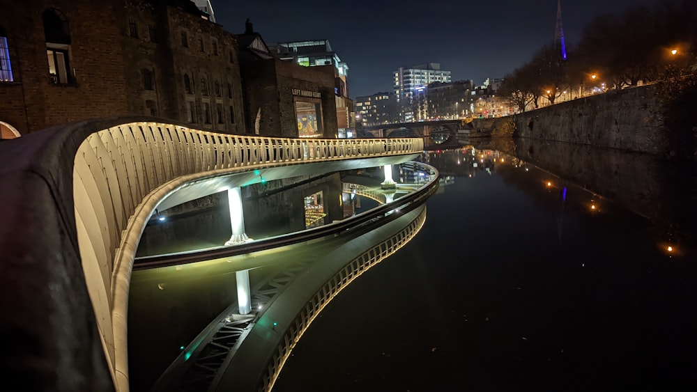 a view of a bridge over a river at night