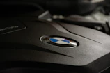 Close-up of a shiny BMW engine cover with the logo clearly visible