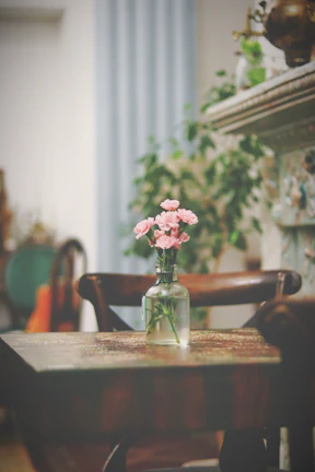 A clean, inviting apartment interior with fresh flowers on the table.