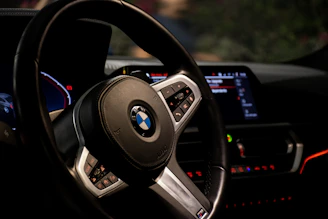 Close-up of a sleek car dashboard illuminated with custom electronic controls.