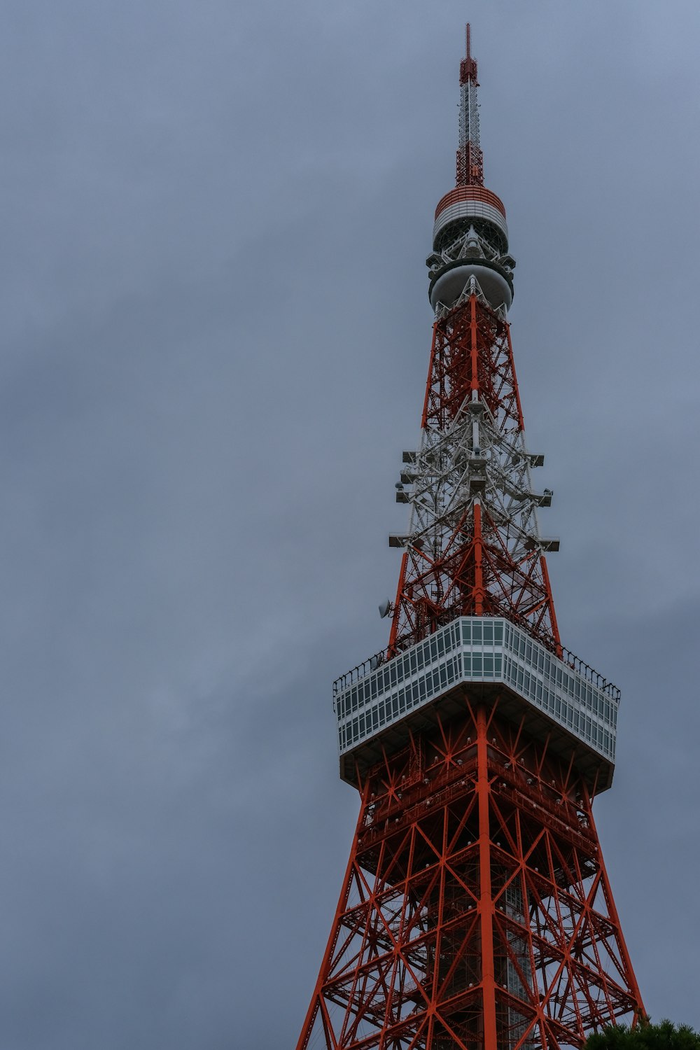 a very tall red tower with a sky background