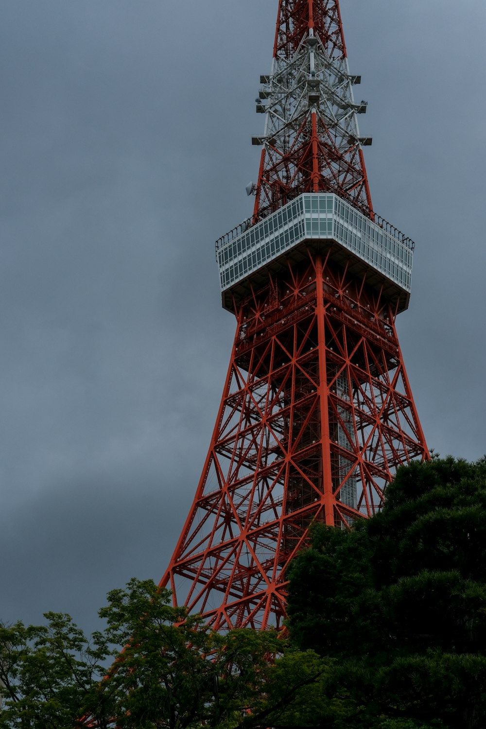 a very tall red tower with a clock on it's side