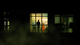 Behind-the-scenes shot of a celebrity interview with bold orange lighting accents.