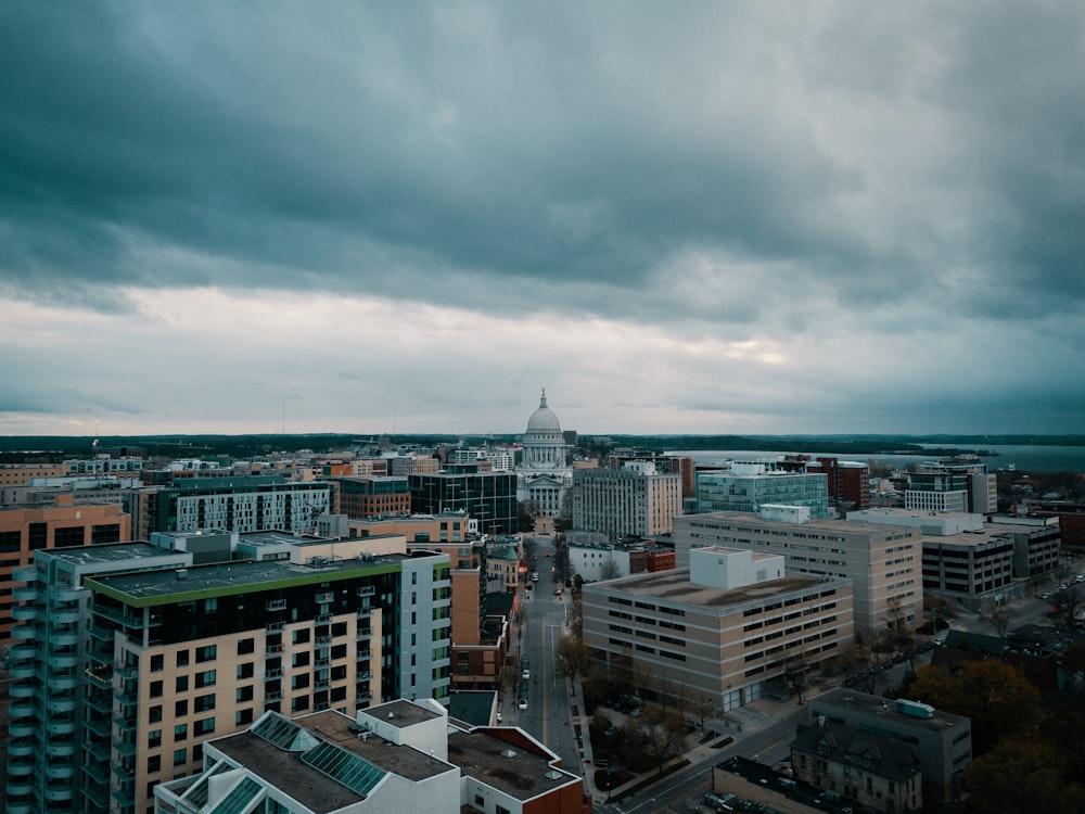 a cloudy sky over a city with tall buildings