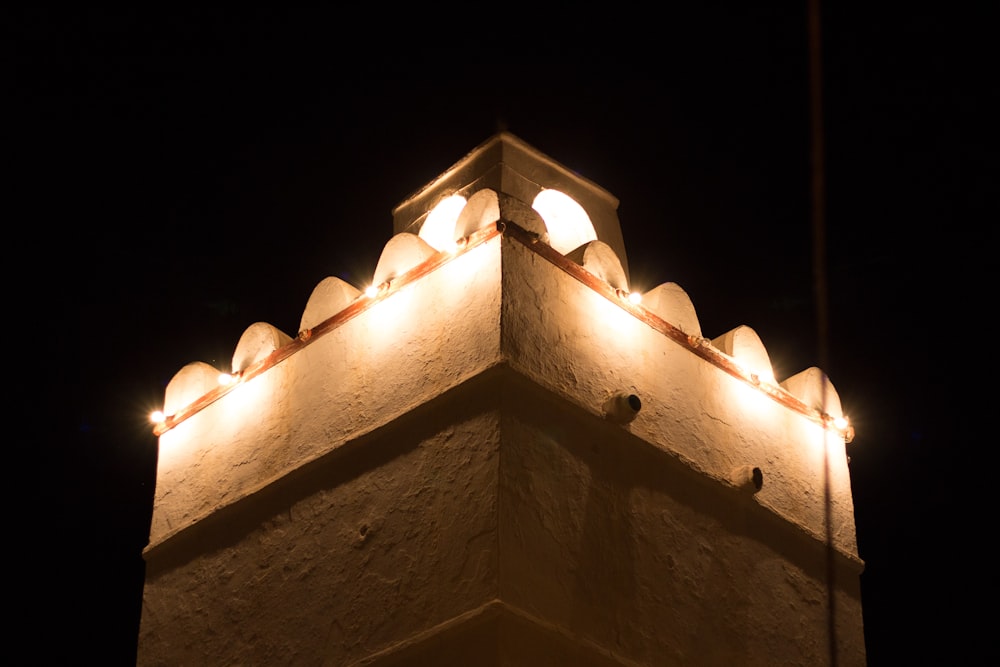 a tall tower with lights on top of it