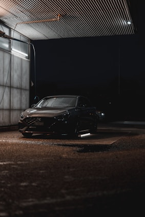 Covered parking lot with a clean car being serviced