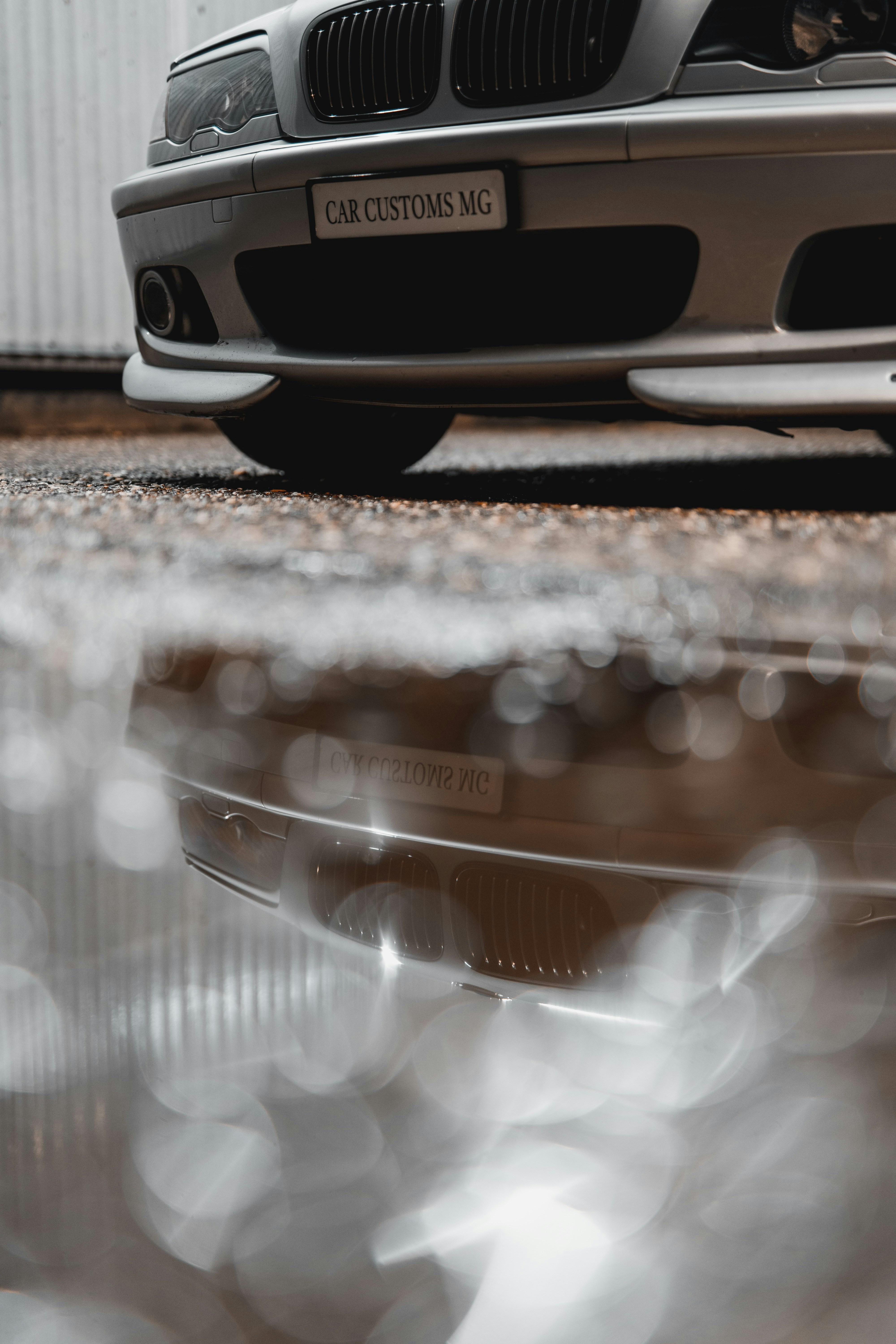 a silver car parked in front of a building