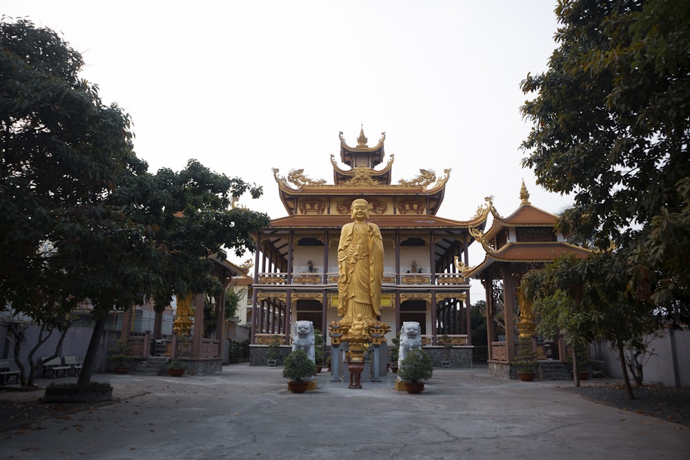 a large golden statue in front of a building