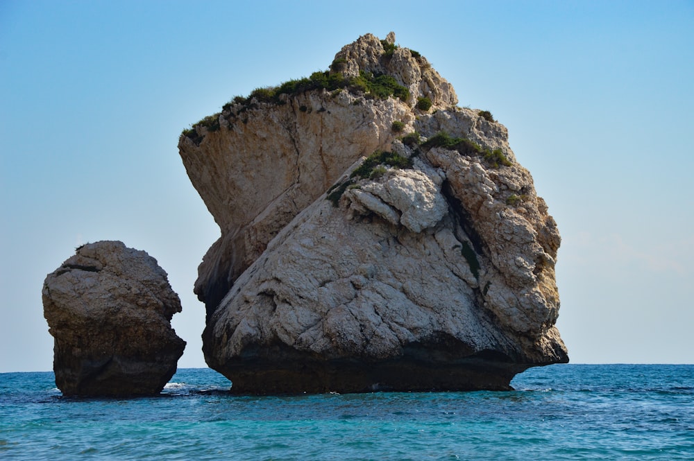 a rock formation in the middle of the ocean