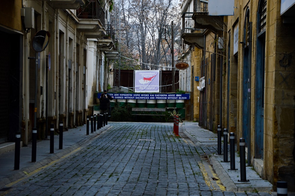 a brick street with a sign on the side of it