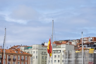 A city skyline with residential buildings and political banners fluttering in the breeze.