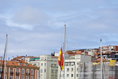 A city skyline with residential buildings and political banners fluttering in the breeze.
